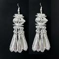 Ornate silver drop earrings with lantern-inspired filigree and tassel details