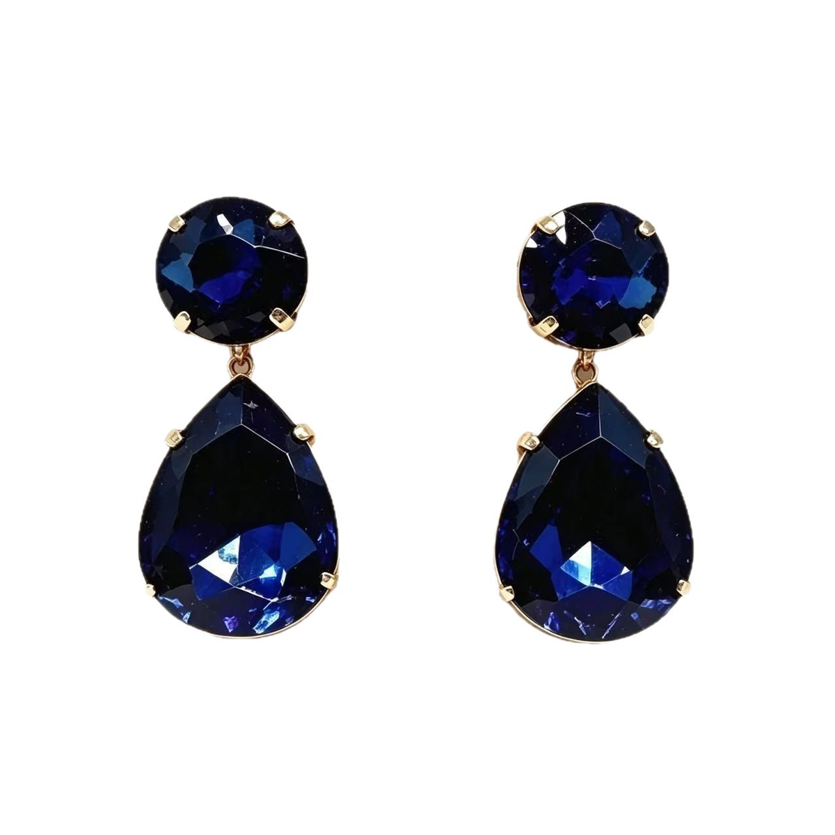 Pair of royal blue faceted crystal teardrop earrings with round crystal tops and gold-tone settings on a white background.